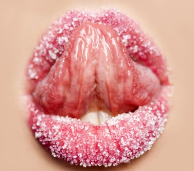 woman lips, tongue licking sugar from lips